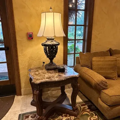 Sale Photo Thumbnail #165: Substantial traditional end table featuring a shaped polished stone top and coordinating carved wood base with scroll legs and architectural stretcher. Designed to coordinate with the larger stone-top coffee table. 26*29*28.5h