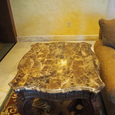Sale Photo Thumbnail #160: Impressive oversized coffee table featuring a shaped natural-stone-style top composed of richly varied tiles over an extensively carved wood base. Scalloped edges, carved apron, substantial legs, and dramatic stretcher base create a true statement piece. 