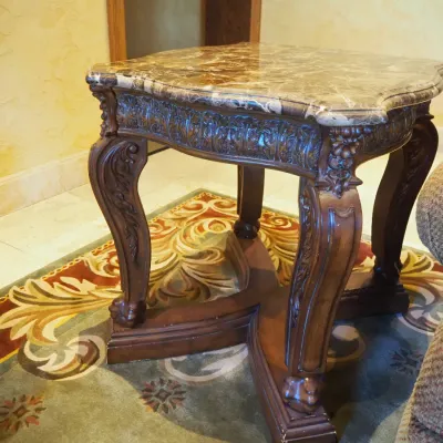 Sale Photo Thumbnail #164: Substantial traditional end table featuring a shaped polished stone top and coordinating carved wood base with scroll legs and architectural stretcher. Designed to coordinate with the larger stone-top coffee table. 26*29*28.5h