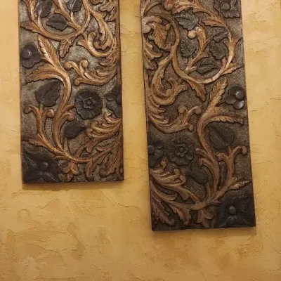 Sale Photo Thumbnail #167: Coordinating pair of tall decorative wall panels featuring raised floral, leaf and scrollwork designs in layered bronze, brown and antiqued gold tones. Each panel measures approximately 15" wide x 35" high and has a substantial dimensional relief that wor
