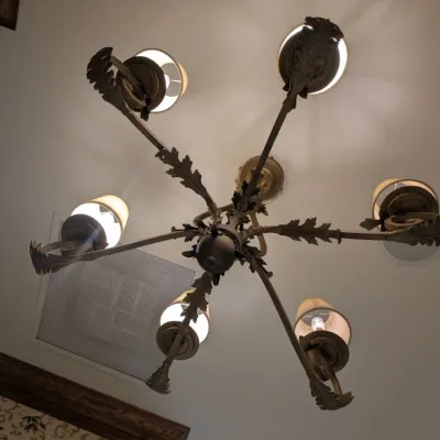 Sale Photo Thumbnail #86: Substantial traditional chandelier featuring scrolling metal arms, dimensional leaf detailing, and coordinating fabric shades. Antiqued bronze/gold finish with elegant Old World design. Buyer responsible for removal. Approx 38" round