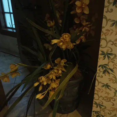 Sale Photo Thumbnail #56: Oversized designer faux floral arrangement with orchids, tropical foliage, and a decorative planter. Substantial commercial-grade décor piece suitable for a foyer, lobby, or large residential space.