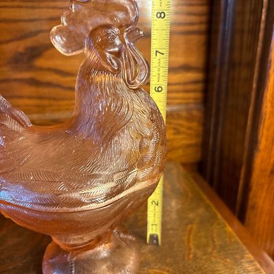 Sale Photo Thumbnail #677: vintage Westmoreland Pink Glass Rooster Covered Dish featuring a translucent peach-pink hue and a pedestal base, popular from the mid-century 1960s era.