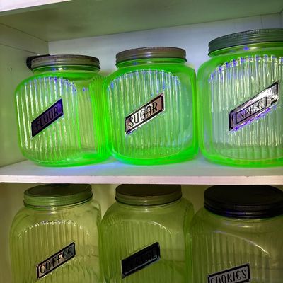 Sale Photo Thumbnail #723: This collection features vintage 1930s Anchor Hocking "Hoosier" ribbed green depression glass jars, made with uranium glass that glows brightly under a UV blacklight.