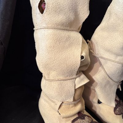 Sale Photo Thumbnail #75: Crafted from buckskin or tanned hide. Featuring folded high cuffs and beaded floral motif.
