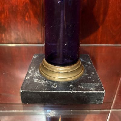 Sale Photo Thumbnail #556: antique Victorian amethyst glass and brass kerosene/oil lamp, likely dating to the late 19th century (circa 1860–1880s), featuring a patterned purple glass font, a brass connector, and a square marble base