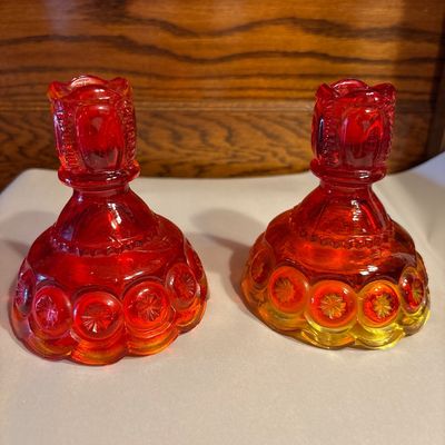 Sale Photo Thumbnail #657: vintage L.E. Smith Glass Co. Amberina "Moon and Stars" pattern candlestick holders, measuring approximately 4.5 inches tall.