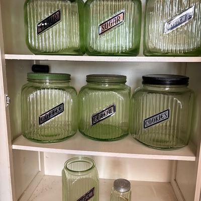 Sale Photo Thumbnail #722: This collection features vintage 1930s Anchor Hocking "Hoosier" ribbed green depression glass jars, made with uranium glass that glows brightly under a UV blacklight.