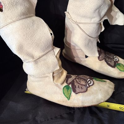 Sale Photo Thumbnail #78: Crafted from buckskin or tanned hide. Featuring folded high cuffs and beaded floral motif.