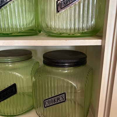 Sale Photo Thumbnail #719: This collection features vintage 1930s Anchor Hocking "Hoosier" ribbed green depression glass jars, made with uranium glass that glows brightly under a UV blacklight.