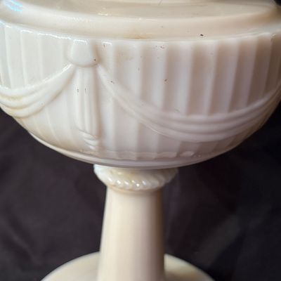 Sale Photo Thumbnail #217: This is a vintage Aladdin Tall Lincoln Drape mantle lamp in ivory Alacite glass, featuring a Nu-Type Model B burner. 26h x 11w.