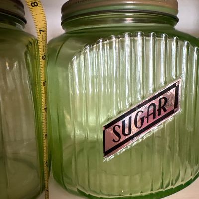 Sale Photo Thumbnail #721: This collection features vintage 1930s Anchor Hocking "Hoosier" ribbed green depression glass jars, made with uranium glass that glows brightly under a UV blacklight.