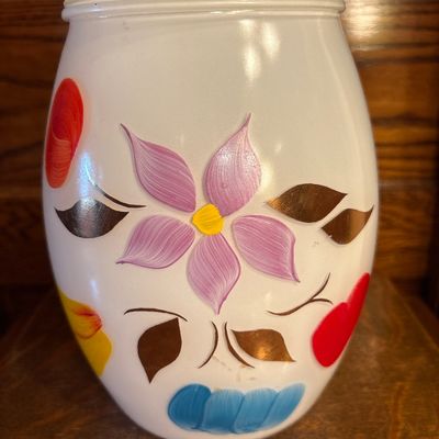 Sale Photo Thumbnail #686: This is a vintage mid-20th-century Bartlett-Collins milk glass cookie jar featuring hand-painted floral and fruit motifs, 1950s. Approx 10” high