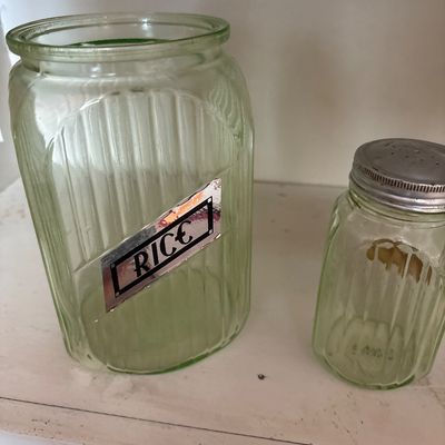 Sale Photo Thumbnail #720: This collection features vintage 1930s Anchor Hocking "Hoosier" ribbed green depression glass jars, made with uranium glass that glows brightly under a UV blacklight.
