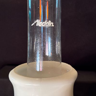 Sale Photo Thumbnail #212: This is a vintage Aladdin Tall Lincoln Drape mantle lamp in ivory Alacite glass, featuring a Nu-Type Model B burner. 26h x 11w.