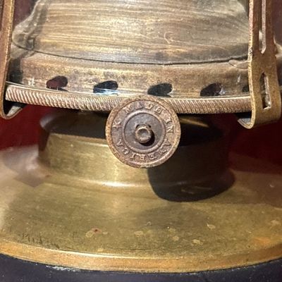 Sale Photo Thumbnail #558: antique Victorian amethyst glass and brass kerosene/oil lamp, likely dating to the late 19th century (circa 1860–1880s), featuring a patterned purple glass font, a brass connector, and a square marble base