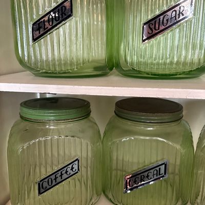 Sale Photo Thumbnail #718: This collection features vintage 1930s Anchor Hocking "Hoosier" ribbed green depression glass jars, made with uranium glass that glows brightly under a UV blacklight.