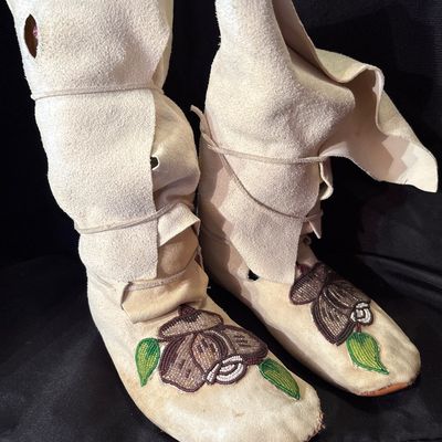 Sale Photo Thumbnail #71: Crafted from buckskin or tanned hide. Featuring folded high cuffs and beaded floral motif.