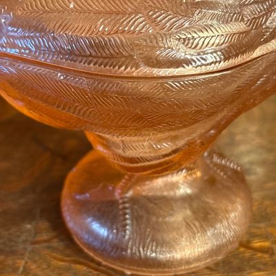 Sale Photo Thumbnail #678: vintage Westmoreland Pink Glass Rooster Covered Dish featuring a translucent peach-pink hue and a pedestal base, popular from the mid-century 1960s era.