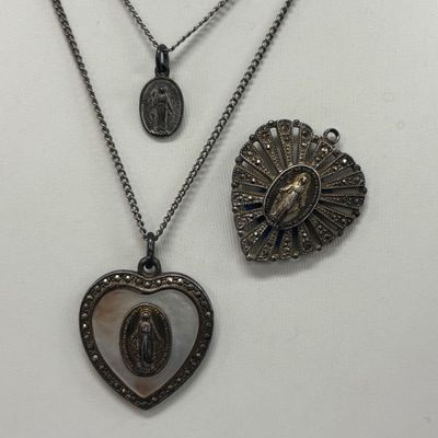 LOT 66: Sterling Miraculous Medal on Mother of Pearl Heart Pendant 7.6gtw (Silver-Tone Chain) with Sterling and Marcasite Miraculous...