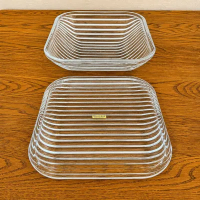 Sale Photo Thumbnail #130: This vintage Villeroy & Boch serving dish is crafted from 24% lead crystal, part of the prestigious Quadra Crystal Collection, made in 1990 in West Germany. The dish features a unique square shape with horizontal ribbed texture, enhancing its elegance and