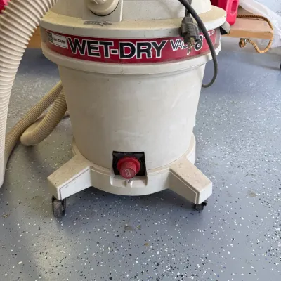 Sale Photo Thumbnail #323: This Craftsman 8 Gallon Wet/Dry Vacuum is designed for versatile cleaning tasks with the ability to handle both wet and dry debris. Featuring a sturdy beige body with red and black branding accents, it includes a durable hose and a robust wheeled base for