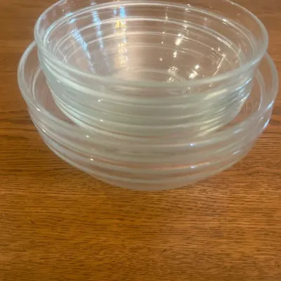 Sale Photo Thumbnail #258: This set includes five clear glass bowls crafted by Durawx, made in France. The bowls vary in size, with diameters approximately ranging from 5 inches to 8 inches, and heights around 2 to 3 inches. These versatile bowls feature a classic, transparent desi