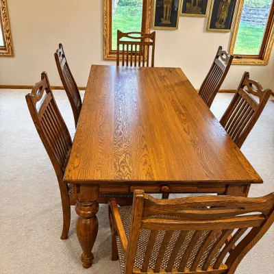 Sale Photo Thumbnail #78: This elegant solid oak dining table set includes six matching chairs, perfect for family meals and gatherings. The table measures 29 inches in height, 82 inches in length, and 39.5 inches in width, providing a spacious surface for dining. Unique to this s