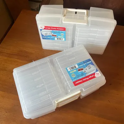 Sale Photo Thumbnail #307: This large photo keeper is designed to securely store and organize a wide variety of photos and small items. Made from durable transparent plastic, it allows easy visibility of contents without opening. The keeper features multiple removable storage compa
