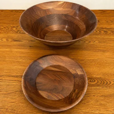 Sale Photo Thumbnail #136: Set of elegant and sturdy salad bowls crafted from rich walnut wood. These bowls feature a natural wood grain finish that enhances their warm brown tones and unique wood patterns. The larger bowl measures approximately 11.5 inches in diameter and about 5 