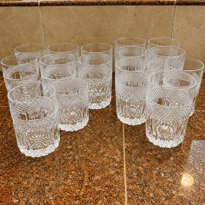 Sale Photo Thumbnail #295: A collection of 14 Libby style old fashion tumblers featuring a radiant pattern highlighted by an intricate diamond cut design. This lot includes two sizes: 9 tumblers measuring 3.75 inches tall and 3 inches wide, and 7 tumblers measuring 4.25 inches tall