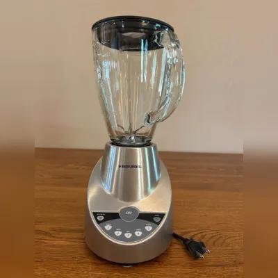 Sale Photo Thumbnail #244: Experience powerful blending with this Black & Decker blender featuring a durable stainless steel base and a clear glass jar. The blender showcases multiple control buttons for versatile blending options, housed in a sleek, modern design. Its stainless st