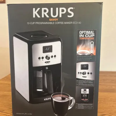 Sale Photo Thumbnail #246: The KRUPS Savoy EC3140 is a 12-cup programmable coffee maker designed for optimal brewing performance. Featuring a sleek black and stainless steel exterior, this coffee maker combines modern aesthetics with durable materials. It boasts programmable settin