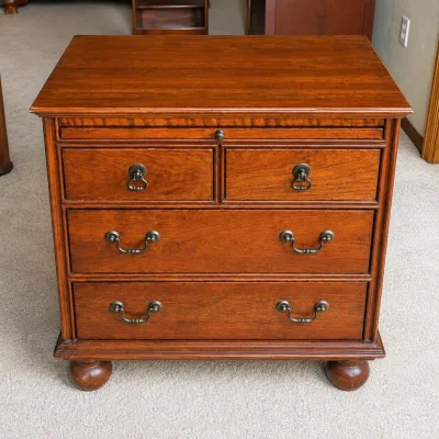 Sale Photo Thumbnail #174: This Lexington Carolina Night Chest is a beautifully crafted wooden nightstand featuring a rich, warm brown finish and traditional design elements. It includes four drawers with antique-style metal handles, offering ample storage space. The nightstand mea