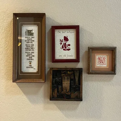 Sale Photo Thumbnail #125: This collection includes four framed wall art pieces, each offering distinctive charm and style. The set features a tall, rectangular frame with a heartfelt blessing text in a neutral palette, highlighted by its dark wooden frame. A smaller red-framed pie