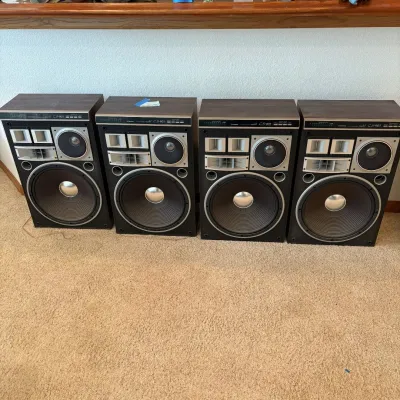 Sale Photo Thumbnail #65: This set features four Pioneer CS-903 speakers known for their robust sound quality and classic design. Each speaker showcases a vintage aesthetic with wood-finished cabinets and multi-driver front panels including large woofers, midrange, and tweeters. T
