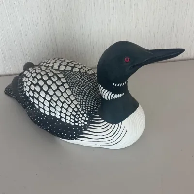 Sale Photo Thumbnail #5: Decorative Common Loon decoy by wildlife artist and renowned carver Sam Nottleman, produced for Wild Wings. The underside retains its original Certificate of Authenticity, identifying the piece as a reproduction of an original woodcarving by Nottleman and