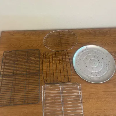 Sale Photo Thumbnail #270: This set features an assortment of baking racks in different sizes and materials, perfect for cooling or baking various treats. Included are multiple wire racks in both black and silver finishes, with measurements ranging from approximately 7 to 15 inches