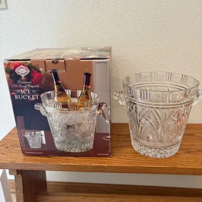 Sale Photo Thumbnail #140: Elegant Shannon European crystal ice bucket featuring 24% lead crystal for enhanced clarity and brilliance. This beautifully crafted piece measures 10 inches tall with a diameter of 9.75 inches. The intricate cut designs and sturdy handles add a touch of 