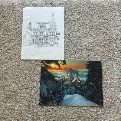 Sale Photo Thumbnail #122: This set features two distinctive art pieces: a detailed black and white architectural print signed by the artist, showcasing intricate linework of a historic house; and a vivid color photograph of SchloB Neuschwanstein blanketed in snow at sunset, highli