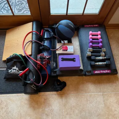 Sale Photo Thumbnail #220: This home gym equipment set features a variety of essential workout tools designed to support strength training, resistance exercises, and cardio routines. Included are multiple pairs of dumbbells in vibrant colors ranging from pink to black, a durable me