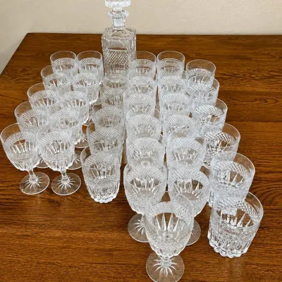 Sale Photo Thumbnail #129: This exquisite Bohemian Crystalex Glasgow glassware set features a stunning diamond cut design, showcasing expert craftsmanship and timeless elegance. The set includes a tall decanter measuring approximately 9 inches in height and multiple crystal glasses