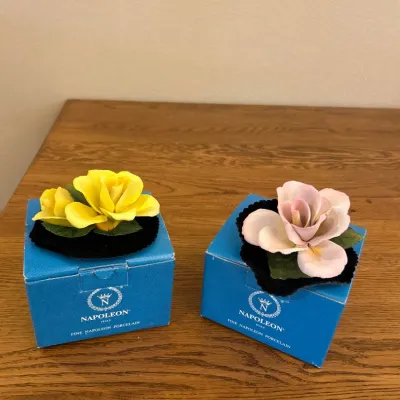 Sale Photo Thumbnail #282: These exquisite Napoleon porcelain flowers feature intricately crafted petals and realistic green leaves, showcasing fine attention to detail. Each flower measures approximately 3 inches in diameter and 2 inches in height, making them perfect for display 