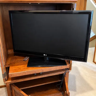 Sale Photo Thumbnail #176: This LG 42LE5300-UC television features a 42-inch LCD screen, offering clear and vibrant picture quality ideal for home entertainment. The TV comes in a sleek black finish and includes multiple input options such as HDMI, USB, component, and composite por