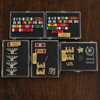 Sale Photo Thumbnail #61: Collection of U.S. Army officer ribbons, rank and uniform insignia presented in five separate clear cases. This grouping comes from the personal military collection of a former U.S. Army battalion commander and includes an extensive assortment representin