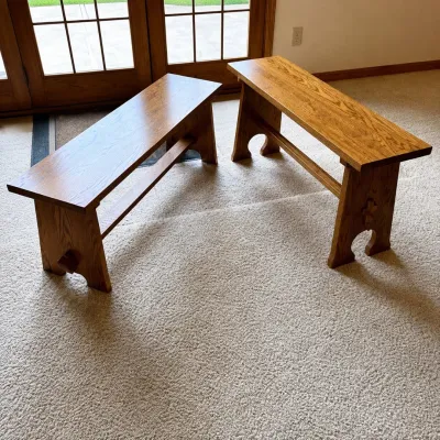 Sale Photo Thumbnail #165: This set features two Stickley Mission Thistle benches, showcasing beautiful craftsmanship with a mortise and tenon joint detail. The benches are constructed from high-quality wood with a warm, rich finish, highlighting the classic Mission style. The firs