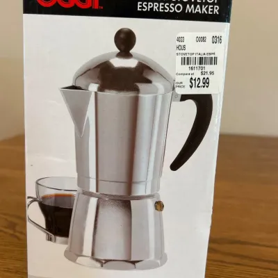 Sale Photo Thumbnail #238: This OGGI stovetop espresso maker brews up to 6 cups of rich espresso with ease. Crafted from heavy-duty polished cast aluminum, it combines durability with classic design. The espresso maker features a heat-resistant black handle and a polished finish, m