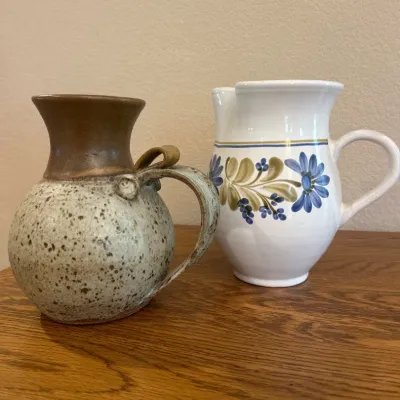 Sale Photo Thumbnail #23: This charming decorative pitchers features a rustic, handmade design with a distinctive speckled glaze that blends earthy beige and brown tones. Measuring approximately 7 inches tall and 6.5 inches wide, it boasts a rounded body and a flared spout for an 