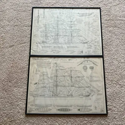 Sale Photo Thumbnail #112: This set features two detailed nautical ship plans illustrating rigging and sail arrangements. Each piece showcases intricate line drawings and technical annotations, perfect for maritime enthusiasts or nautical decor lovers. The prints are framed with sl