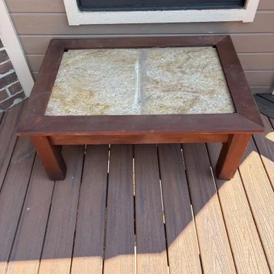 Sale Photo Thumbnail #188: This rectangular coffee table features a sturdy wooden frame with a rich, dark finish and a top surface composed of two large travertine tiles that can be interchangeable with other types of large tiles.The table measures 18 inches tall, 41 inches wide, a